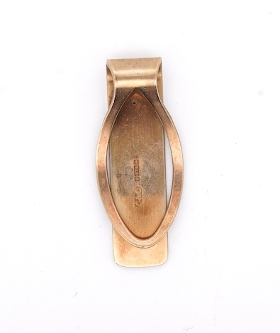 A 1980's 9ct gold tie clip, 39mm and a similar 9ct gold and black onyx set signet ring, gross weight 10 grams.
